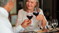 Elderly woman toasting wine with her husband at a smart restaurant